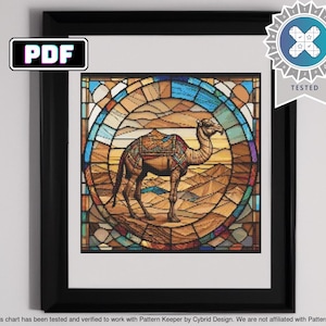 May include: A stained glass style cross stitch pattern featuring a camel in a desert landscape. The camel is brown and tan with a saddle and is walking through a desert scene with sand dunes and blue sky. The pattern is surrounded by a colorful border.