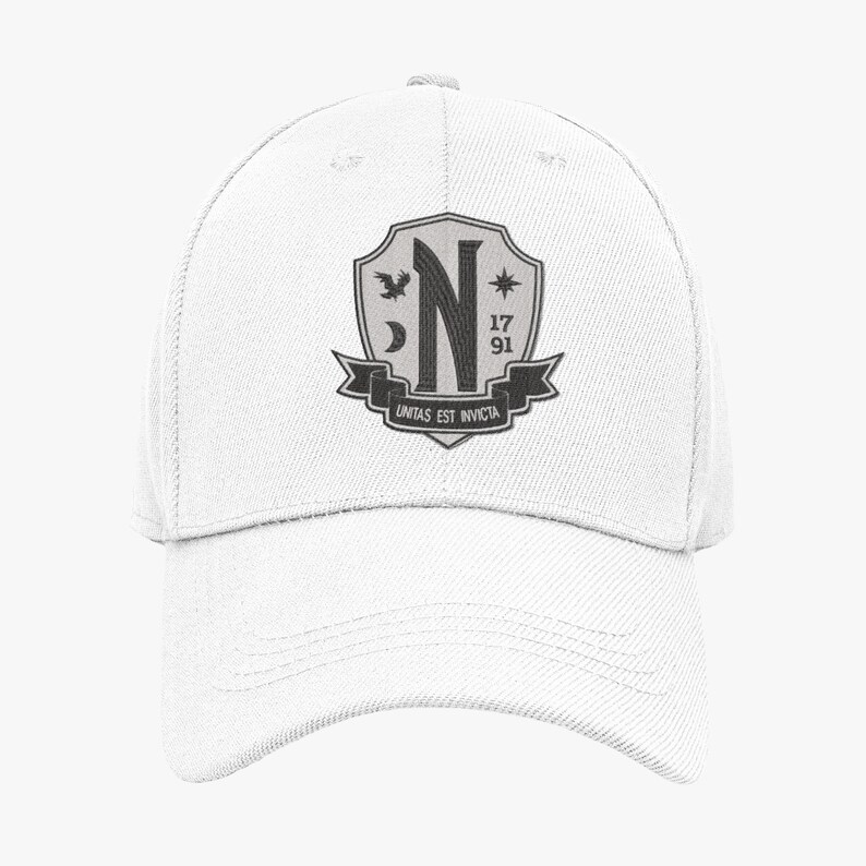 May include: White baseball cap with a black and gray embroidered crest featuring a letter N, a bird, a crescent moon, a star, and the text "unitas est invicta" and the numbers "17 91".