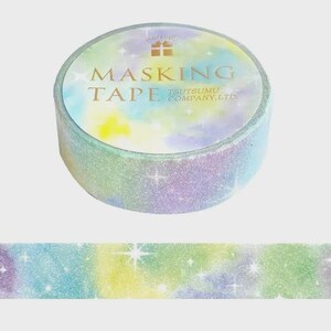 May include: A roll of masking tape featuring a pastel tie-dye pattern in shades of yellow, blue, and purple with a glittery finish and white starburst accents. The label on the top reads MASKING TAPE TSUTSUMU COMPANY, LTD. with a small gift icon.