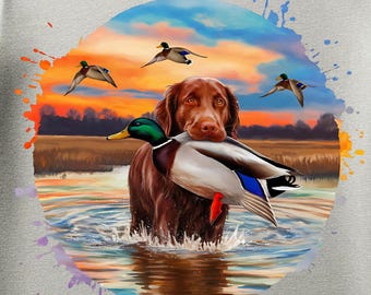 May include: Light gray t-shirt featuring a circular graphic of a brown dog in water, carrying a duck. The background shows a sunset and flying ducks. The text "PNG File Only" is at the top. The text "Please note, this is a digital item - no physical product will be shipped" is at the bottom.