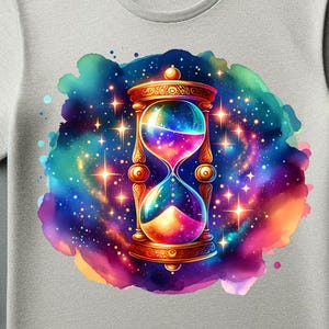 May include: A light gray t-shirt featuring a colorful hourglass design with a galaxy background. The hourglass is gold-colored with a rainbow gradient inside. The text "PNG File Only" is visible. The shirt is a digital item.