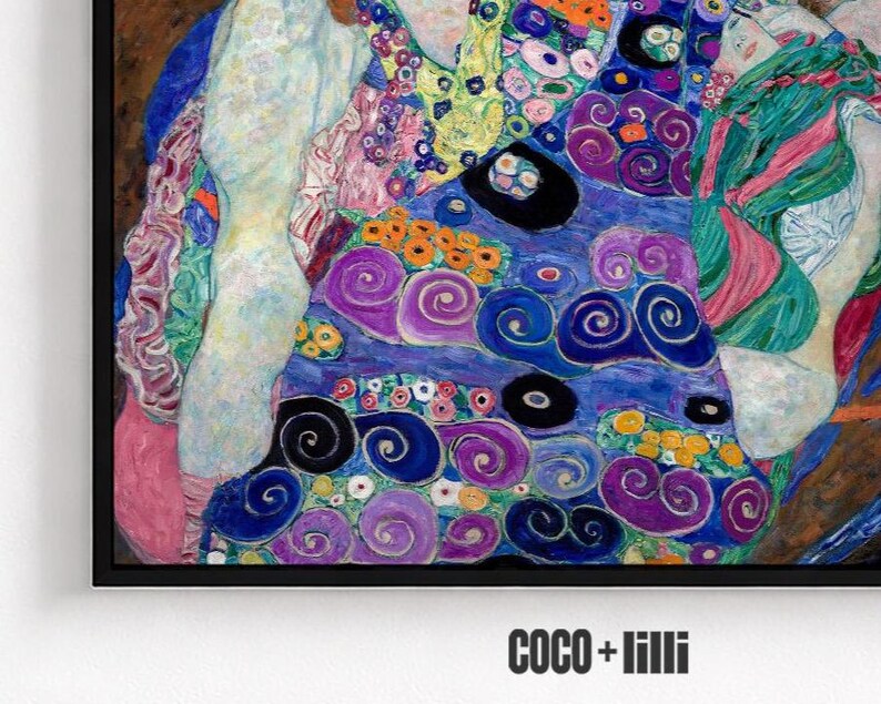 May include: A framed art print featuring a vibrant, abstract composition with swirling patterns in shades of blue, purple, pink, and green, accented by small yellow and orange circular motifs. The text COCO + lilli appears in black at the bottom.