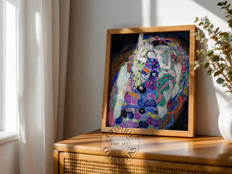 May include: A framed art print featuring a reproduction of Gustav Klimt's The Virgin, displaying multiple figures in a swirling composition of blue, purple, green, and gold patterns, enclosed in a light-toned wooden frame with a circular logo.
