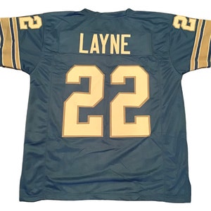 May include: A teal blue football jersey with gold trim and the name "LAYNE" and number "22" on the back.