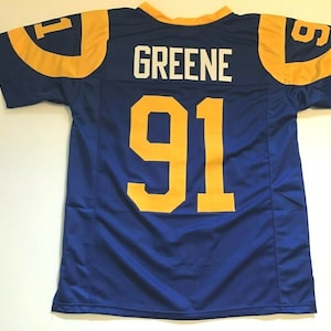 May include: A blue football jersey with yellow trim and the number 91 on the back. The name "GREENE" is printed above the number.