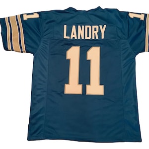 May include: Teal blue football jersey with gold trim and the name "LANDRY" and number "11" on the back.