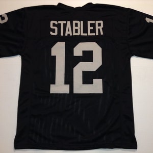 May include: Black football jersey with the name "STABLER" and the number "12" in silver on the back.