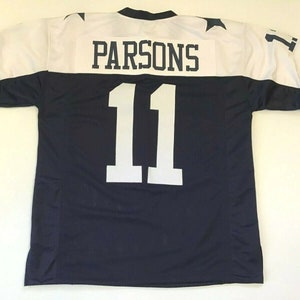 May include: A navy blue football jersey with white lettering. The jersey has the name "PARSONS" and the number "11" on the back.