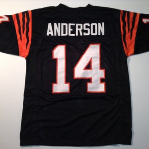 May include: Black football jersey with orange and black tiger stripes on the sleeves. The jersey has the name "ANDERSON" and the number "14" on the back.