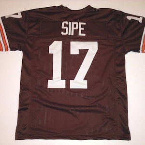 May include: Brown football jersey with white lettering. The jersey has the name "SIPE" and the number "17" on the back.