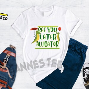 May include: White t-shirt with a green alligator graphic and the text "See you later alligator".
