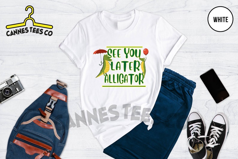 May include: White t-shirt with a green alligator graphic and the text "See you later alligator".