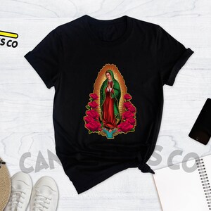 May include: Black t-shirt with a graphic print of the Virgin Mary surrounded by red roses.