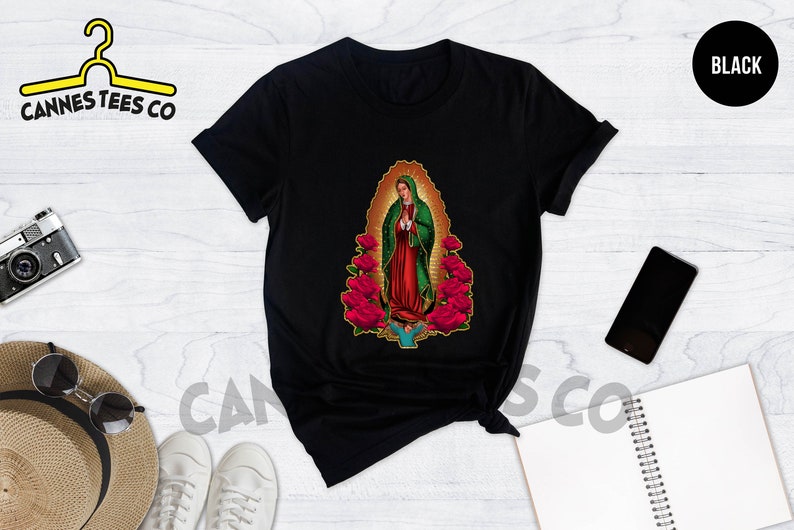 May include: Black t-shirt with a graphic print of the Virgin Mary surrounded by red roses.