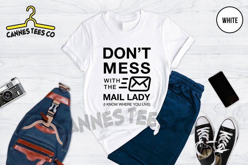 May include: White t-shirt with black text that reads "Don't Mess With The Mail Lady (I Know Where You Live)" and a black envelope icon.
