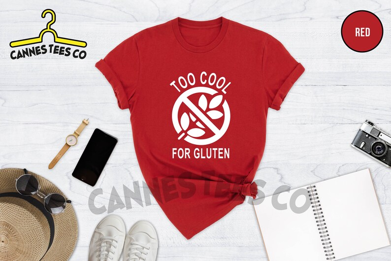 May include: Red t-shirt with a white graphic that says "Too Cool For Gluten" and a white gluten-free symbol.