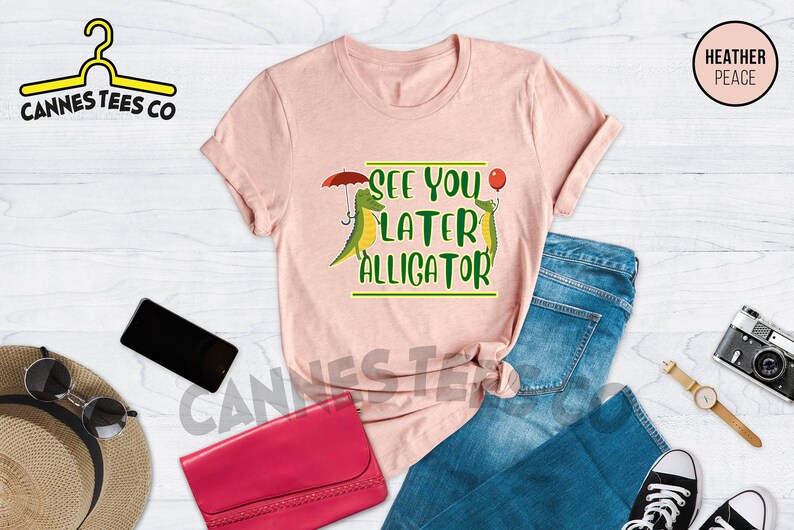 May include: A pink t-shirt with a green alligator graphic and the text "See you later alligator".