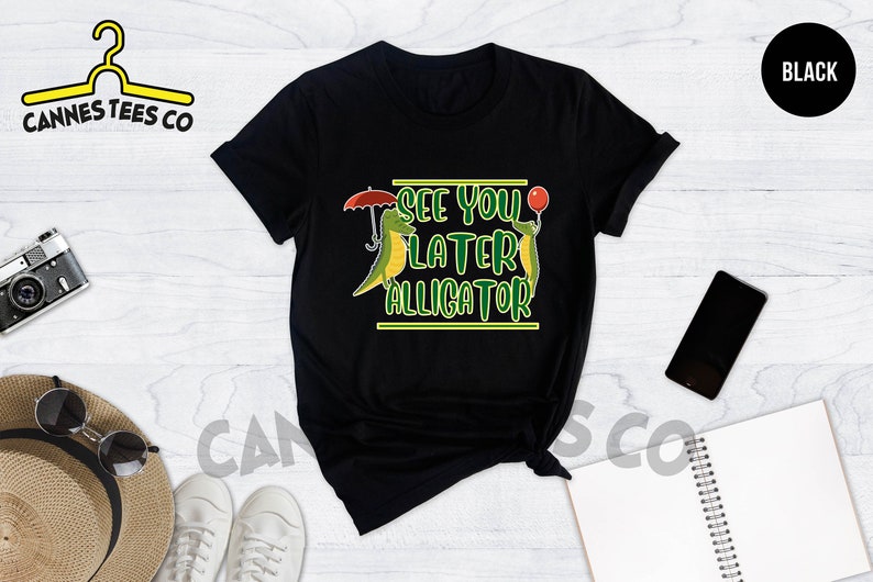 May include: Black t-shirt with a green alligator graphic and the text "See you later alligator".