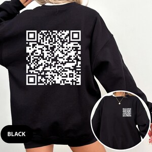 May include: Black sweatshirt with a white QR code printed on the back. The sweatshirt has long sleeves and a crew neck.