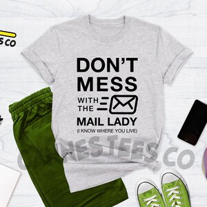 May include: Heather grey t-shirt with black text that reads "Don't Mess With The Mail Lady (I Know Where You Live)" and a black envelope graphic.
