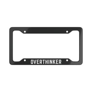 May include: A black car number plate frame with the word "OVERTHINKER" in white. The frame is rectangular with rounded corners and four mounting holes. The text is centered.