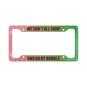 May include: A car license plate frame with a pink and green gradient, decorated with white star shapes. The frame features the text "WE CAN'T ALL COME" and "AND GO BY BUBBLE" in black lettering.