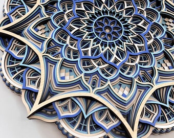 May include: A blue and brown layered mandala wall art with intricate geometric patterns. The mandala is made of wood and has a 3D effect.
