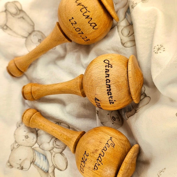 Wooden baby rattle labeled