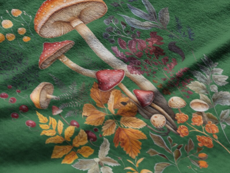 May include: A close-up of a green fabric with a watercolor illustration of mushrooms, leaves, and berries. The mushrooms have red and brown caps with white spots. The leaves are yellow, orange, and brown.