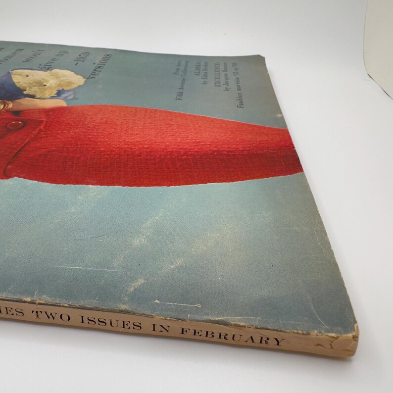 May include: A vintage magazine cover featuring a woman wearing a red dress. The cover text reads "Two Issues in February".