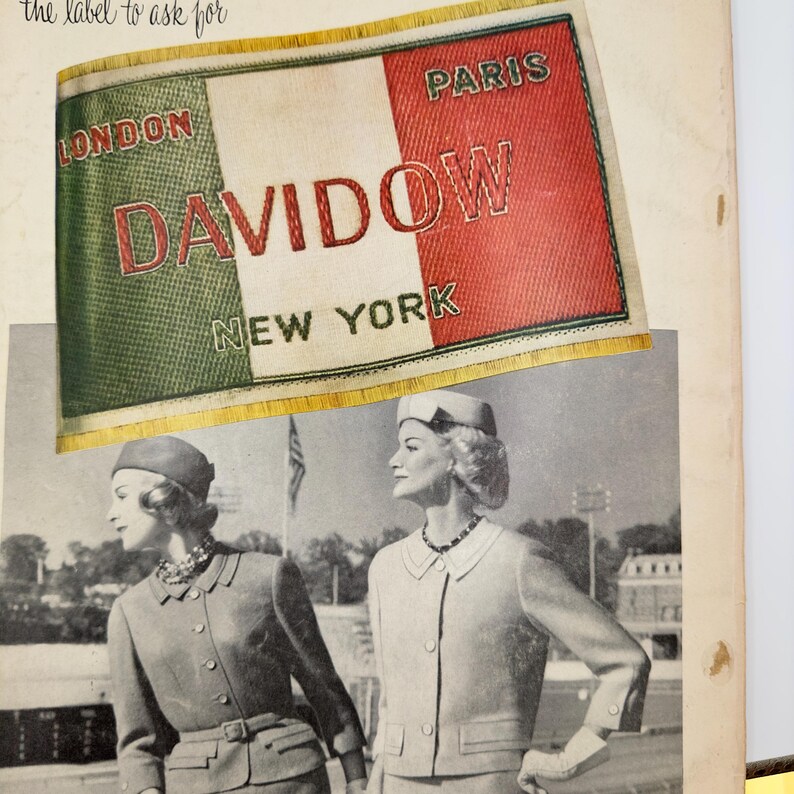 May include: A vintage label for Davidow clothing with the text "London, Paris, New York" in a green, white, and red color scheme.