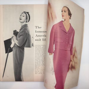 May include: A vintage magazine spread featuring two women wearing pink and grey suits. The text reads "The famous American suit life".