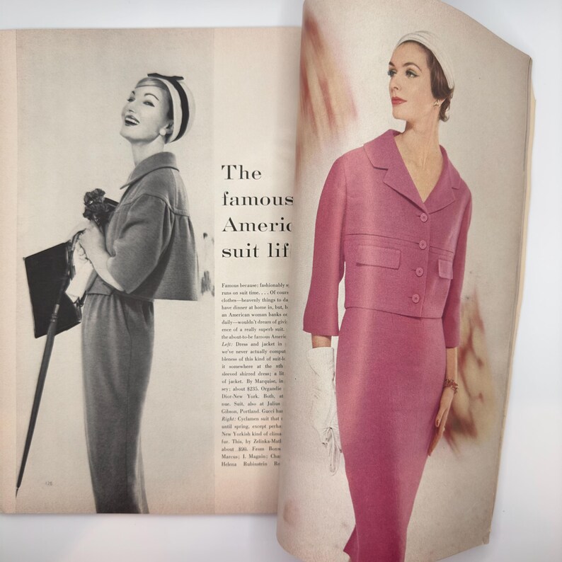May include: A vintage magazine spread featuring two women wearing pink and grey suits. The text reads "The famous American suit life".