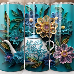 May include: A teal blue tumbler with a white teapot and colorful paper flowers. The flowers are made of paper and are in shades of blue, yellow, pink, and green. The teapot has a blue and white floral design.