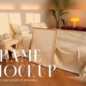 May include: A white frame mockup on a wooden floor in a bedroom setting. The frame is leaning against a bed with white bedding and a bedside table with a cup and books. The text "FRAME MOCKUP" is displayed below the frame, and the text "Elevate your prints & artworks" is displayed below the text "FRAME MOCKUP".