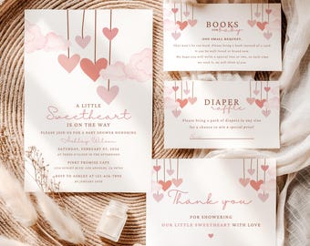 May include: A baby shower invitation set featuring white cards with pink watercolor hearts and clouds. The text includes A LITTLE Sweetheart IS ON THE WAY, BOOKS FOR BABY, DIAPER raffle, and Thank you, with event details for Ashley Wilson.