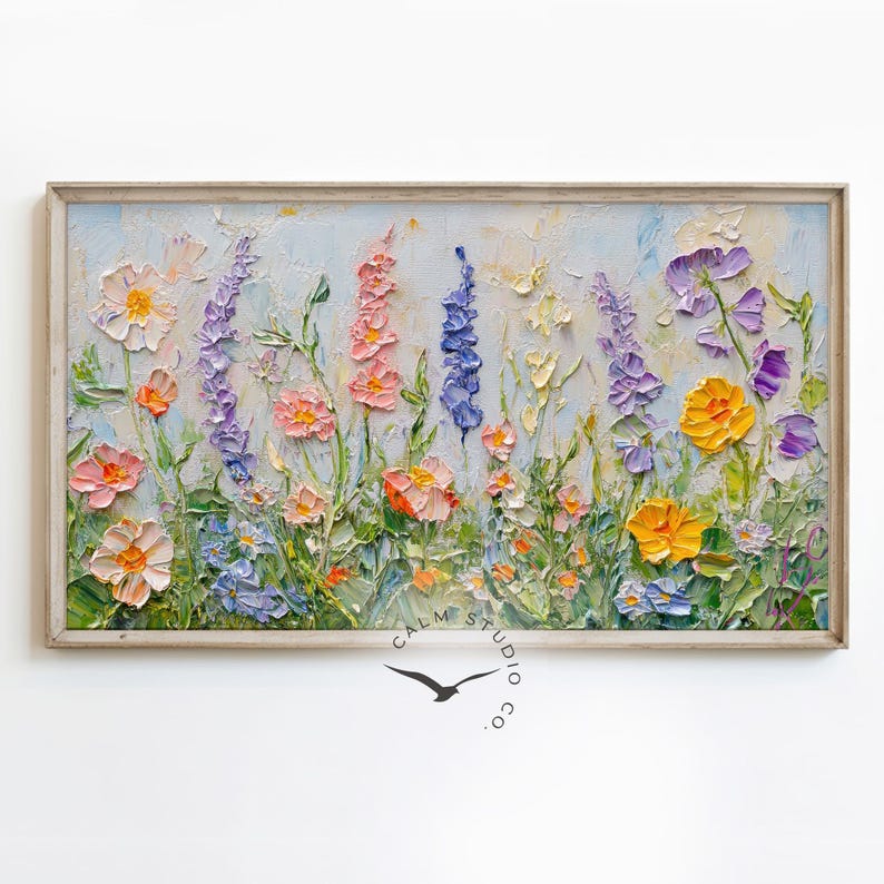 May include: A framed oil painting of a wildflower meadow. The artwork features a variety of colorful flowers in shades of pink, yellow, purple, and blue, with green stems and leaves. The painting is signed "Calm Studio co."