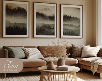 May include: Three framed landscape prints of a misty forest scene hang on a beige wall above a brown leather sectional sofa with throw pillows and a woven coffee table. The coffee table has a vase with dried flowers and a book on top.