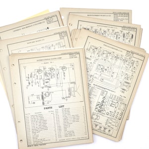 May include: A stack of vintage radio schematic diagrams, including diagrams for International Radio Corp., Montgomery Ward & Co., and Wellsgardner & Co. The diagrams are printed on white paper with black ink and have a hole punched on the left side for binding.