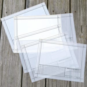 May include: A stack of translucent vellum sheets featuring printed black technical drafting borders and grid lines. Each sheet displays a rectangular frame with corner details and a title block in the bottom right corner labeled American Car and Foundry Co.