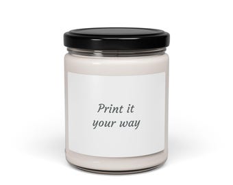 May include: A white candle in a clear glass jar with a black lid. The candle has a white label with the text "Print it your way" in a dark gray font. The candle is on a white background.