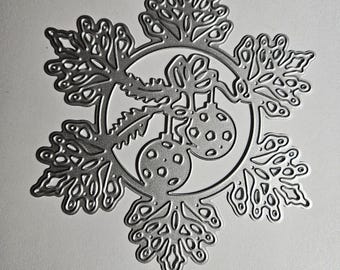 May include: A silver-colored metal snowflake ornament with intricate cut-out details. The design includes a central circle with two hanging ornaments and detailed snowflake points, perfect for holiday decorations.