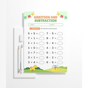 May include: A white worksheet with the title "ADDITION AND SUBTRACTION" in green and orange. The worksheet includes addition and subtraction problems with blank spaces for answers. A pencil, eraser, and another pencil are on the left.