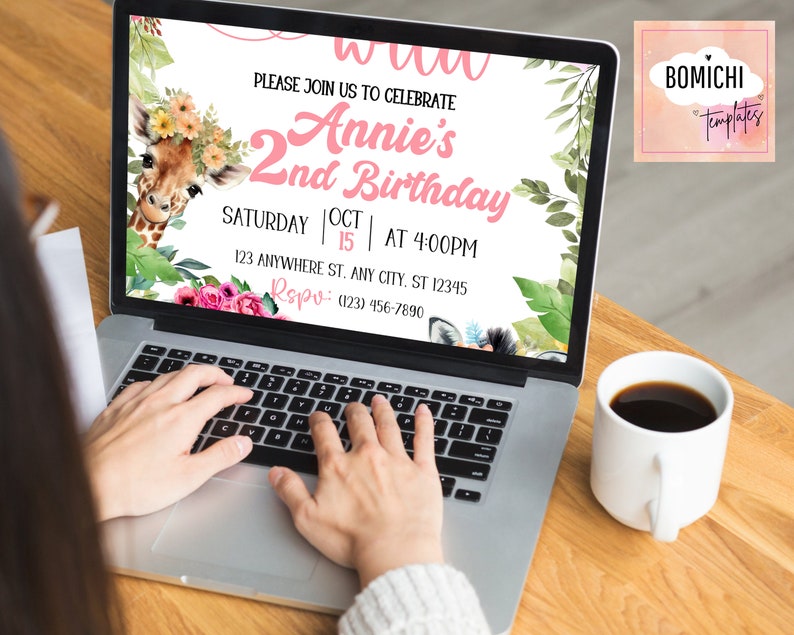 May include: A laptop computer screen displaying a pink and green birthday invitation for a girl named Annie's 2nd birthday. The invitation features a giraffe with a flower crown and the text "PLEASE JOIN US TO CELEBRATE Annie's 2nd Birthday SATURDAY OCT 15 | AT 4:00PM 123 ANYWHERE ST. ANY CITY. ST 12345 RSVP: (123) 456-7890".