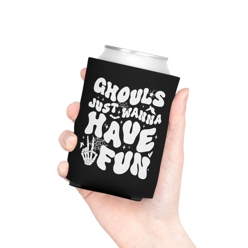 May include: Black and white can cooler with the text "Ghouls Just Wanna Have Fun" in a retro font. The design includes bats, stars, and a skeleton hand with a peace sign.