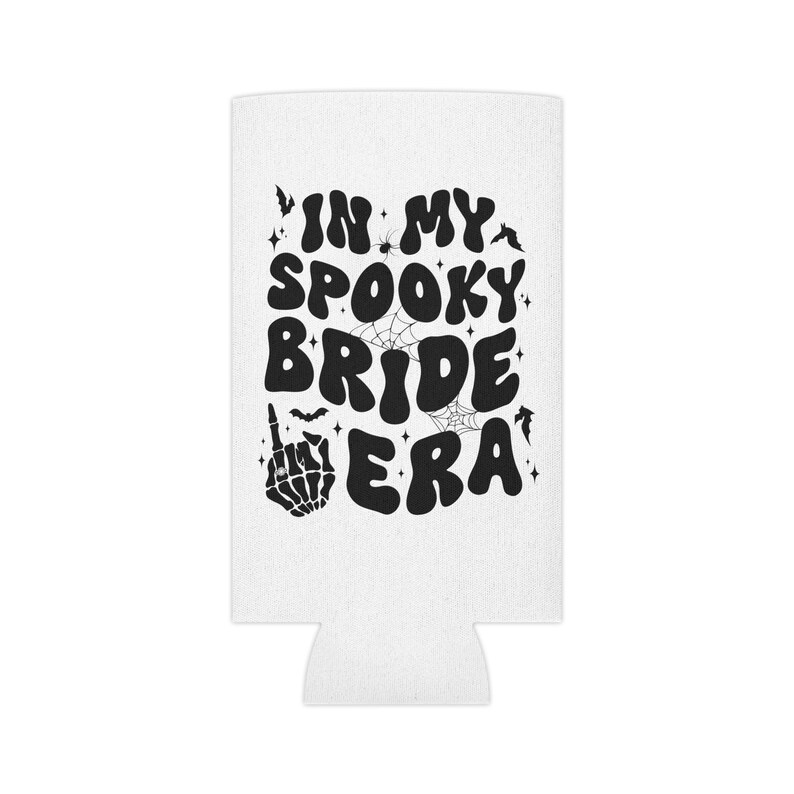 May include: White can cooler with black text that reads "In My Spooky Bride Era". The text is in a retro font with a skeleton hand giving the middle finger and bats and spiderwebs surrounding the text.