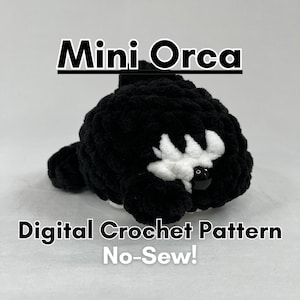 May include: A black and white crocheted mini orca plush toy. The orca has a black body and a white patch around its eye. The toy is a no-sew crochet pattern. "Mini Orca Digital Crochet Pattern No-Sew!" is written in black text on a white background.