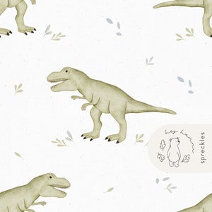 May include: Watercolor pattern featuring olive green Tyrannosaurus Rex dinosaurs, with small gray and green leaf and dot accents, on a white background. The design includes a small logo with a bear and the text "hey haa spreckles".