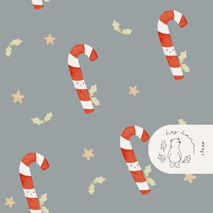 May include: A repeating pattern of red and white candy canes with smiling faces, gold stars, and green holly leaves on a gray background. The candy canes are curved and have white stripes. The pattern is whimsical and festive.
