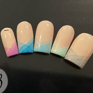 May include: Five nude-colored artificial nails with a gradient design. The nails are painted with a light blue, light green, light gray, and pink color at the tips.